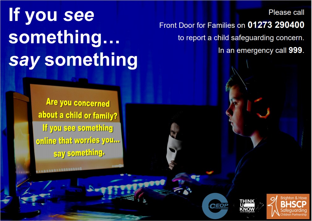 A teenage boy looking at a computer screen with headphones on. the room is dark and the computer says 'are you worried about a child online? if you see something... say something'